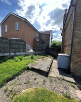 Small overgrown residential backyard