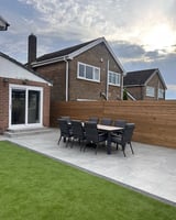 Modern brick home with patio dining area